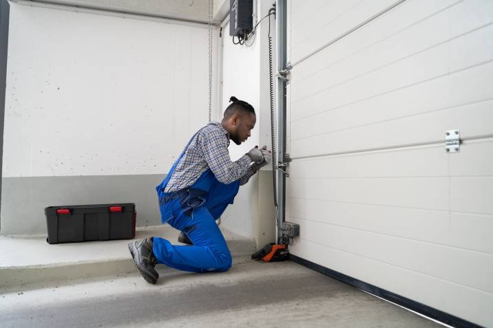 Garage,Door,Installation,And,Repair,At,Home.,Contractor,Man,In