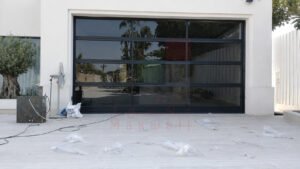 Types of Garage Doors in Dubai: A Complete Guide 4 Black garage door with red-brown trim on a Dubai property