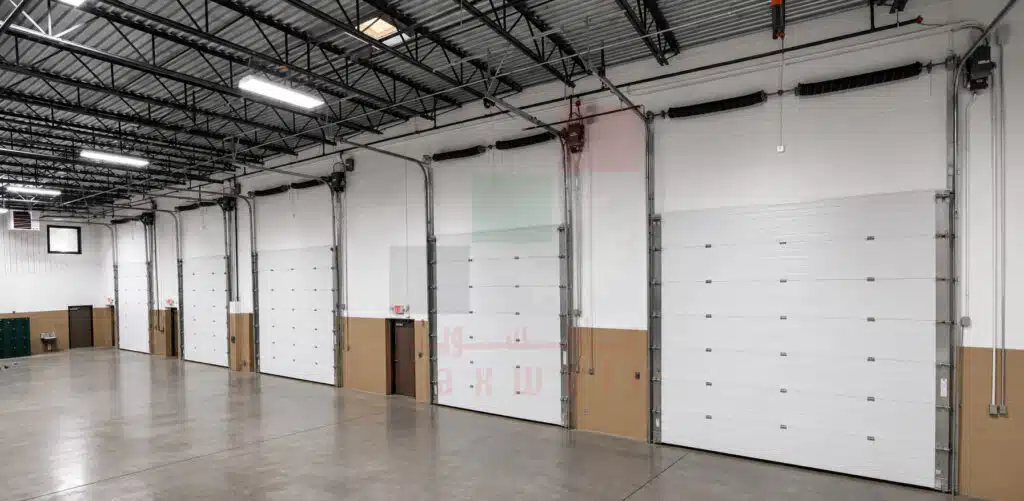 White overhead garage door installed inside an industrial facility in Dubai