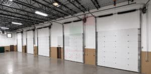 How to Buy a Garage Door in UAE - Complete 2026 Buying Guide 6 White overhead garage door installed inside an industrial facility in Dubai